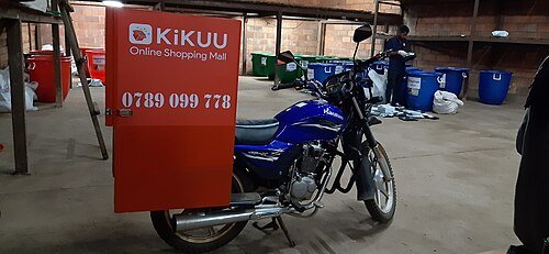 Home deleivery motorcycle parked in a warehouse at Kigali