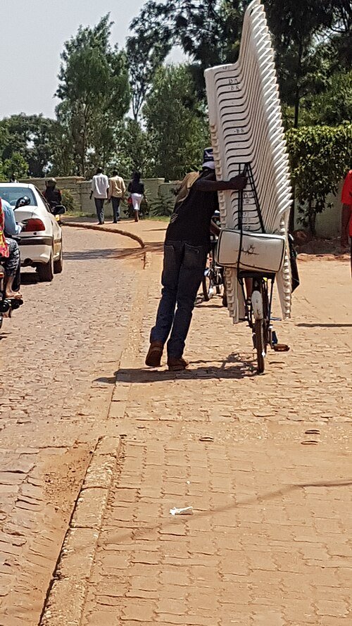 Transporting Chairs on Bicycle, Kigali, Rwanda, probably from a wedding or other type of reception.